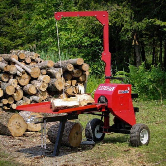 Red RRF40TL – 40 Tons Kinetic Log Splitter with logs in a forest setting