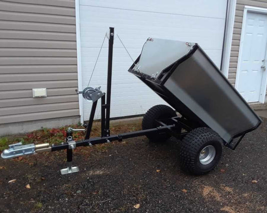 Single Axle Dump Trailer with Hand Winch in tilted position, showcasing its manual winch system and high-capacity dump function for hauling dirt, rocks, and more.