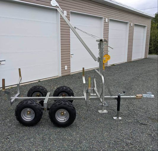 Side view of Walking Beam Logging Trailer with Crane Kit, showcasing its heavy-duty frame, tandem wheels, and adjustable boom for efficient lifting and transport.