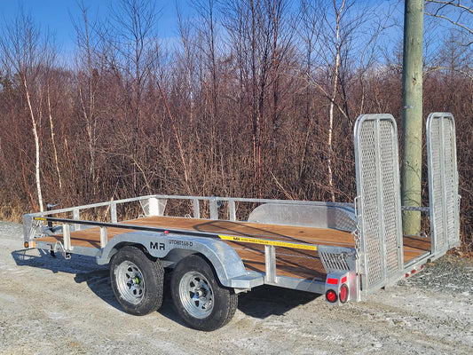 Maxi-Roule galvanized double axle trailer side view highlighting dual axles, rear mesh ramps, and side railing.