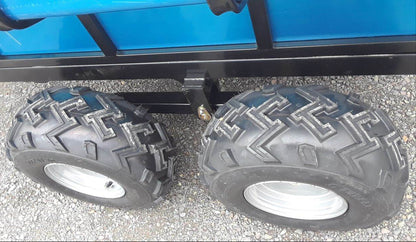 Close-up of two large black tires with tread pattern on ATV Hydraulic Dump Trailer
