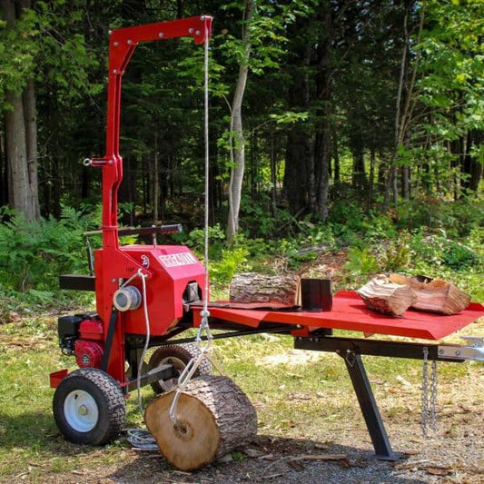Red RRF40TL – 40 Tons Kinetic Log Splitter in a forest setting with logs and a table.