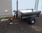 Single Axle Dump Trailer with Hand Winch in resting position, featuring a durable steel frame, large off-road tires, and a manual winch for easy dumping.