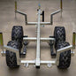 Heavy-duty ATV/UTV walking beam logging trailer with a galvanized frame, tandem wheels, and removable bunks for efficient log hauling.