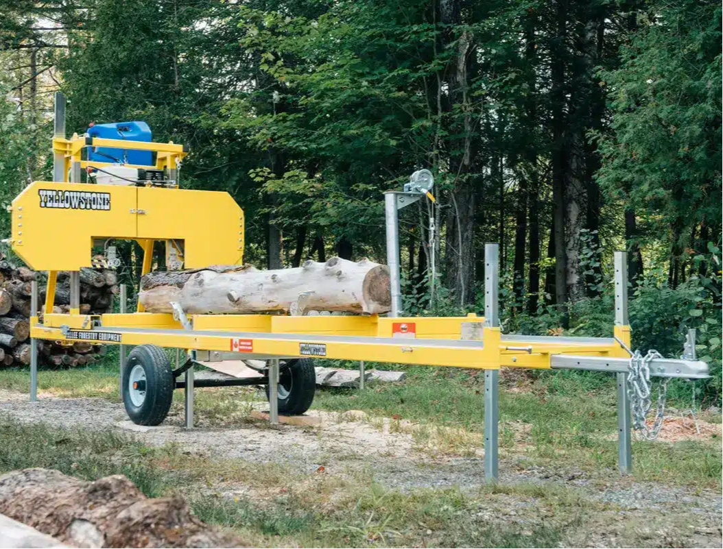 Yellow log splitting Yellowstone Vallee Sawmill in a forest setting