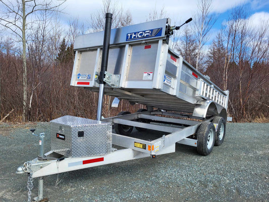 Aluminum dump trailer with lifted bed, front and side view showing hydraulic cylinder and toolbox.